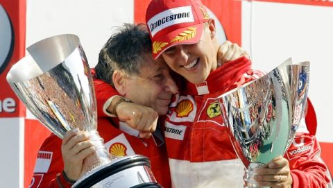 Ferrari driver Michael Schumacher, right, celebrates on the podium with team manager Jean Todt after winning the Formula One Grand Prix of Italy, at the Monza racetrack, near Milan, Italy, Sunday, Sept. 10, 2006. Seven-time world champion Michael Schumacher announced his retirement from Formula One on Sunday, moments after winning the Italian Grand Prix. (AP Photo/Antonio Calanni) 