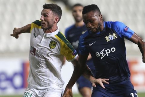 Apostolos Giannou of AEK Larnaca, left, challenge for the ball with Umaru Bangura of Zurich during the Europa League group A soccer match between AEK Larnaca and Zurich at GSP stadium in Nicosia, Cyprus, Thursday, Sept. 20, 2018. (AP Photo/Petros Karadjias)