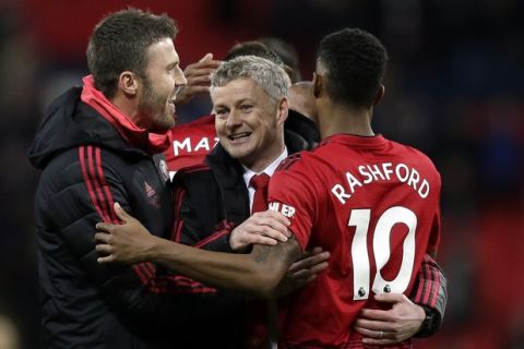 Manchester United caretaker manager Ole Gunnar Solskjaer, center, celebrates with Manchester United's Marcus Rashford, right, at the end of the English Premier League soccer match between Tottenham Hotspur and Manchester United at Wembley stadium in London, England, Sunday, Jan. 13, 2019. Manchester United won 1-0. (AP Photo/Tim Ireland)