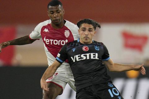 Trabzonspor's Abdulkadir Omur, right, challenges with Monaco's Jean Lucas during the Europa League group H soccer match between Monaco and Trabzonspor at the Stade Louis II in Monaco, Thursday, Oct. 6, 2022. (AP Photo/Daniel Cole)