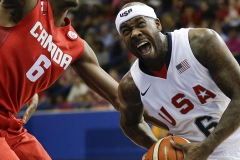 United States' Bobby Brown, right, battles against Canada Melvin Ejim during a men's basketball semifinal game at the Pan Am Games in Toronto, Ontario, Friday, July 24, 2015. (AP Photo/Felipe Dana)