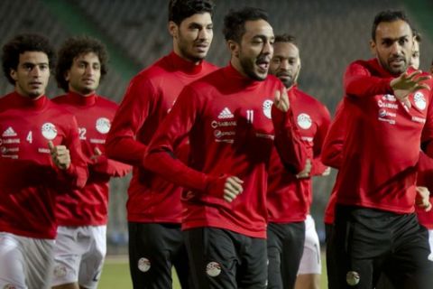 Players of the Egyptian national soccer warm up, during training at Cairo stadium, Monday, Nov. 6, 2017, in preparation for their Nov. 12 away game against Ghana in the last African Group E World Cup qualifier, in Cairo, Egypt. Argentinian coach of the Egyptian national soccer team, Hector Cuper, made a spirited defense of his tactics during a press conference on Monday, saying a different strategy may not have taken the Pharaohs to the 2018 World Cup in Russia. (AP Photo/Amr Nabil)
