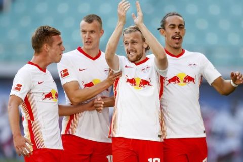 Leipzig's Emil Forsberg celebrates with team mate after scoring with a penalty during a German Bundesliga soccer match between RB Leipzig and FSV Mainz 05 in Leipzig, Germany, Sunday, Sept.20, 2020.( Jan Woitas/dpa via AP)