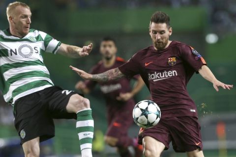 Barcelona's Lionel Messi, right, challenges for the ball with Sporting's Jeremy Mathieu, during a Champions League, Group D soccer match between Sporting CP and FC Barcelona at the Alvalade stadium in Lisbon, Wednesday Sept. 27, 2017. (AP Photo/Armando Franca)