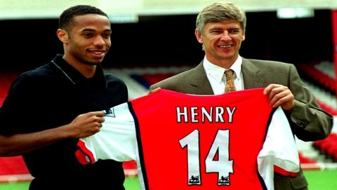 FILE - In this Tuesday, August 3, 1999 file photo Arsenal's latest signing, Thierry Henry, left, with Manager Arsene Wenger,  pictured at Highbury in north London.  Thierry Henry has announced his retirement following a 20-year career. The 37-year-old Henry, a member of the France teams that won the 1998 World Cup and 2000 European Championship, will take up a media role as a consultant for Sky Sports channel.  (AP Photo/Robin Nowacki, File)