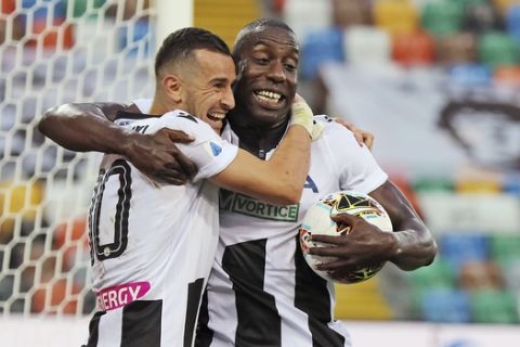 Udinense's Ilija Nestorovski, left, celebrates with his teammate Stefano Okaka after scoring his side's first goal during a Serie A Soccer match between Udinese and Juventus, in Udine, Italy, Thursday, July 23, 2020. (Andrea Bessanutti/LaPresse via AP)