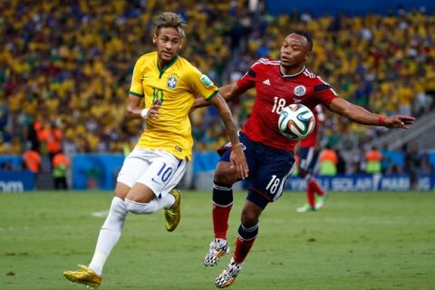 FORTALEZA, BRAZIL - JULY 04: Neymar of Brazil competes for the ball with Juan Camilo Zuniga of Colombia during the 2014 FIFA World Cup Brazil Quarter Final match between Brazil and Colombia at Castelao on July 4, 2014 in Fortaleza, Brazil.  (Photo by Gabriel Rossi/Getty Images)