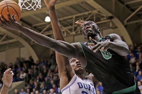 Duke's Wendell Carter Jr (34) defends against Utah Valley's Akolda Manyang (0) during the second half of an NCAA college basketball game in Durham, N.C., Saturday, Nov. 11, 2017. Duke won 99-69. (AP Photo/Gerry Broome)