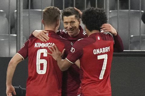 Bayern's Robert Lewandowski is celebrated after he scored his third goal during the Champions League, round of 16, second leg soccer match between Bayern and Salzburg in Munich, Germany, Tuesday, March 8, 2022. (AP Photo/Matthias Schrader)