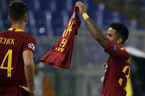Roma forward Justin Kluivert, left, celebrates by holding a jersey with his own number '"34" after he scored his side fourth goal during the Champions League, group G soccer match between Roma and Viktoria Plzen at the Rome Olympic Stadium, in Rome, Italy, on Tuesday, Oct. 2, 2018. (AP Photo/Andrew Medichini)