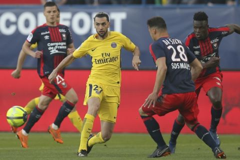 Javier Pastore of Paris Saint Germain controls the ball against Damien Da Silva of Caen during their League One soccer match at the Michel d'Ornano stadium in Caen, western France, Saturday, May 19, 2018. This is his last match with the PSG team. German coach Thomas Tuchel will replace him for the next season. (AP Photo/David Vincent)