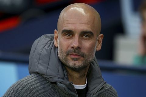 Manchester City coach Pep Guardiola waits for the start of the Champions League quarterfinal, second leg, soccer match between Manchester City and Tottenham Hotspur at the Etihad Stadium in Manchester, England, Wednesday, April 17, 2019. (AP Photo/Dave Thompson)