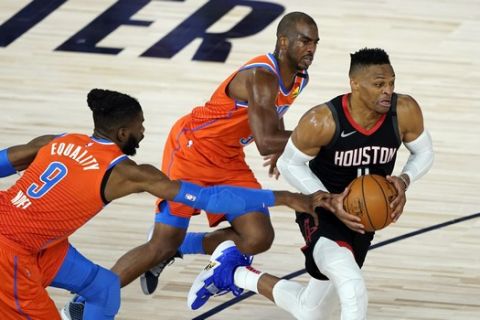 Houston Rockets' Russell Westbrook, right, drives toward the basket as Oklahoma City Thunder's Nerlens Noel (9) and Chris Paul defend during the second half of an NBA basketball first round playoff game Saturday, Aug. 29, 2020, in Lake Buena Vista, Fla. (AP Photo/Ashley Landis)