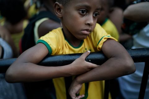 A young Brazil soccer fan stands dejectedly on a railing after watching his team loose in a live broadcast of the World Cup quarterfinal match with Belgium, in Rio de Janeiro, Brazil, Friday, July 6, 2018. Belgium knocked Brazil out of the World Cup and advanced to the semi-finals. (AP Photo/Leo Correa)