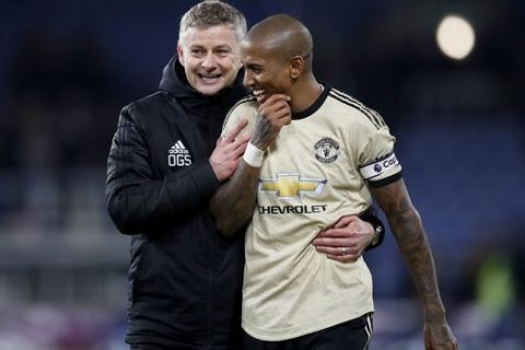 Manchester United manager Ole Gunnar Solskjaer, left, hugs Ashley Young after the English Premier League soccer match at Turf Moor, Burnley, England, Saturday, Dec. 28, 2019. (Martin Rickett/PA via AP)