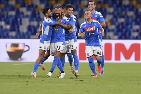 Napoli's Elseid Hysaj, second left, celebrates with his teammates after scoring the first goal during the Italian Serie A soccer match between Napoli and Sassuolo, at the San Paolo stadium in Naples, Italy, Saturday, July 25, 2020. (Cafaro/LaPresse via AP)