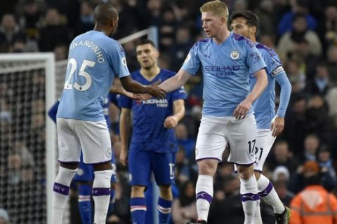 Manchester City's Kevin De Bruyne celebrates with Fernandinho, left, after scoring his side's first goal during the English Premier League soccer match between Manchester City and Chelsea at Etihad stadium in Manchester, England, Saturday, Nov. 23, 2019. (AP Photo/Rui Vieira)