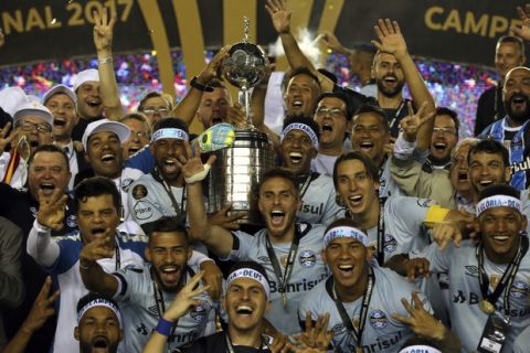 Brazil's Gremio soccer team celebrates winning the Copa Libertadores championship after playing Argentina's Lanus in Buenos Aires, Argentina, Wednesday, Nov. 29, 2017. (AP Photo/Esteban Felix)