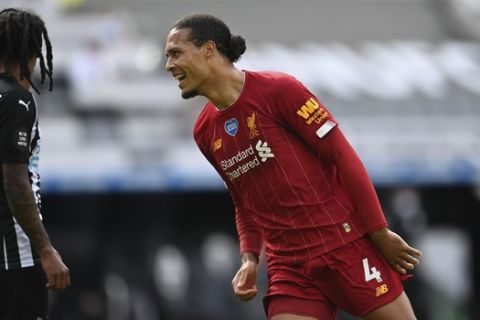 Liverpool's Virgil van Dijk celebrates after scoring his side's first goal during the English Premier League soccer match between Newcastle and Liverpool at St. James' Park in Newcastle, England, Sunday, July 26, 2020. (Laurence Griffiths, Pool via AP)