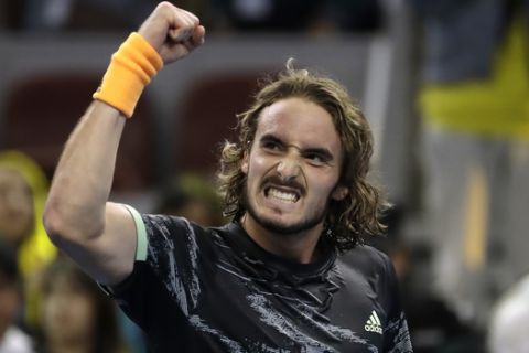 Stefanos Tsitsipas of Greece celebrates after defeating Alexander Zverev of Germany in their semifinal match in the China Open tennis tournament in Beijing, Saturday, Oct. 5, 2019. (AP Photo/Mark Schiefelbein)
