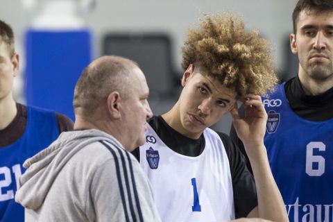 Lithuanian Basketball club Prienai-Birstonas Vytautas head coach Virginijus Seskus, left, talks to his player LaMelo Ball during a training session at the BC Prienai-Birstonas Vytautas arena in Prienai, Lithuania, Friday, Jan. 5, 2018. LiAngelo Ball and LaMelo Ball have signed a one-year contract to play for Lithuanian professional basketball club Prienai - Birstonas Vytautas, in the southern Lithuania town of Prienai, some 110 km (68 miles) from the Lithuanian capital Vilnius.(AP Photo/Mindaugas Kulbis)