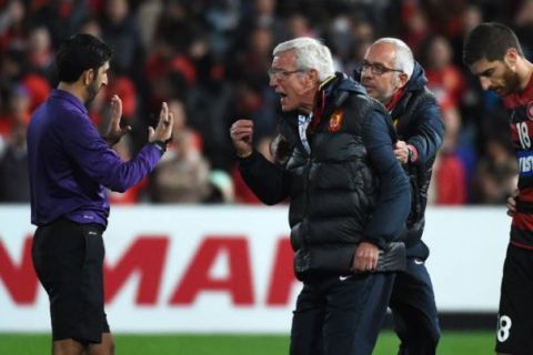 Guangzhou Evergrande coach Marcello Lippi (C) confronts referee Mohammad Abdulla Hassan Mohamed (L) after having a second player sent off against the Western Sydney Wanderers during their AFC Champions League quarter-final football match in Sydney on August 20, 2014.  AFP PHOTO/William WEST  --IMAGE RESTRICTED TO EDITORIAL USE - STRICTLY NO COMMERCIAL USE--WILLIAM WEST/AFP/Getty Images