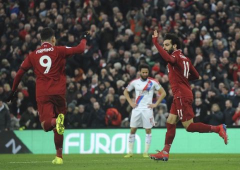 Liverpool's Mohamed Salah, right, celebrates with his teammate Liverpool's Roberto Firmino after scoring his side's opening goal during the English Premier League soccer match between Liverpool and Crystal Palace at Anfield in Liverpool, England, Saturday, Jan. 19, 2019. (AP Photo/Rui Vieira)