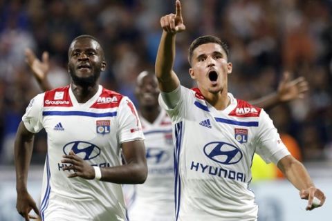 Lyon's Houssem Aouar, right, celebrates after he scored a goal against Marseille during their French League One soccer match in Decines, near Lyon, central France, Sunday, Sept. 23, 2018. (AP Photo/Laurent Cipriani)