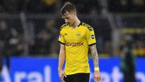 Dortmund's Marco Reus leaves the pitch disappointed after the German Bundesliga soccer match between Borussia Dortmund and RB Leipzig in Dortmund, Germany, Tuesday, Dec. 17, 2019. The match ended 3-3. (AP Photo/Martin Meissner)