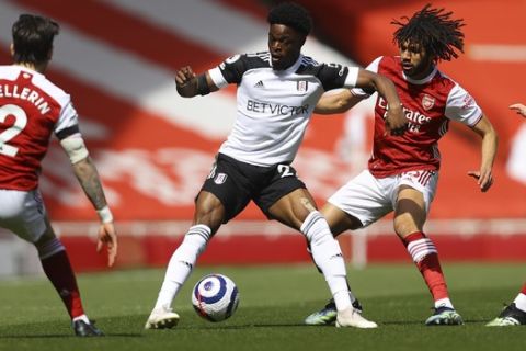 Fulham's Josh Maja, centre, holds off Arsenal's Mohamed Elneny during an English Premier League soccer match between Arsenal and Fulham at the Emirates stadium in London, England, Sunday April 18, 2021. (Julian Finney/Pool via AP