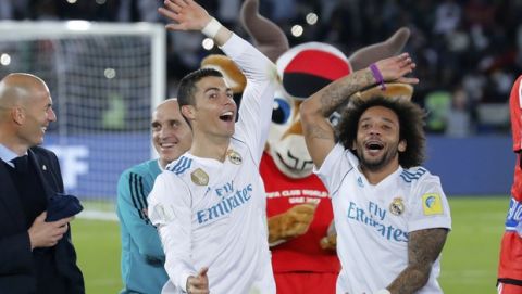 Real Madrid's Cristiano Ronaldo and Marcelo, right, celebrate after winning the Club World Cup final soccer match between Real Madrid and Gremio at Zayed Sports City stadium in Abu Dhabi, United Arab Emirates, Saturday, Dec. 16, 2017. (AP Photo/Hassan Ammar)