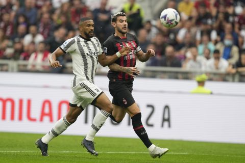 Juventus' Bremer, left, and AC Milan's Theo Hernandez vie for the ball during the Serie A soccer match between AC Milan and Juventus at the San Siro stadium, in Milan, Italy, Saturday, Oct. 8, 2022. (AP Photo/Antonio Calanni)