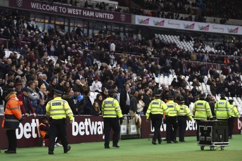 Police secure the area after a pitch invader ran onto the pitch during the English Premier League soccer match between Burnley and West Ham at the Olympic London Stadium in London, Saturday, March 10, 2018. (Daniel Hambury/PA via AP)