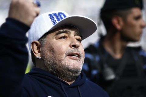 Former soccer great Diego Maradona gestures to fans during his presentation as Gimnasia y Esgrima La Plata's new head coach in La Plata, Argentina, Sunday, Sept. 8, 2019. (AP Photo/Marcos Brindicci)