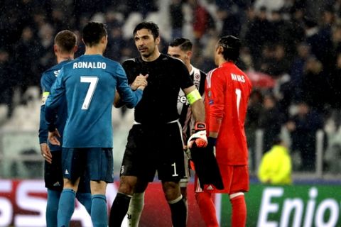 Juventus goalkeeper Gianluigi Buffon, right, shakes hands with Real Madrid's Cristiano Ronaldo after the Champions League, round of 8, first-leg soccer match between Juventus and Real Madrid at the Allianz stadium in Turin, Italy, Tuesday, April 3, 2018. Real won 3-0. (AP Photo/Luca Bruno)