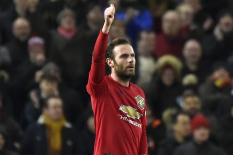 Manchester United's Juan Mata celebrates after scoring his side's first goal during the English FA Cup third round replay soccer match between Manchester United and Wolverhampton Wanderers at Old Trafford in Manchester, England, Wednesday, Jan. 15, 2020. (AP Photo/Rui Vieira)