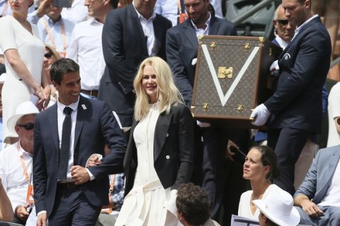 Actress Nicole Kidman and French Olympic champion Tony Estanguet arrive to present the men's trophy before Spain's Rafael Nadal plays Switzerland's Stan Wawrinka in their final match of the French Open tennis tournament at the Roland Garros stadium, Sunday, June 11, 2017 in Paris. (AP Photo/David Vincent)