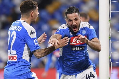 Napoli's Konstantinos Manolas, right, celebrates after scoring during a Serie A soccer match between Napoli and Torino at the San Paolo Stadium in Naples, Italy, Saturday, Feb. 29, 2020. (Cafaro/LaPresse via AP)