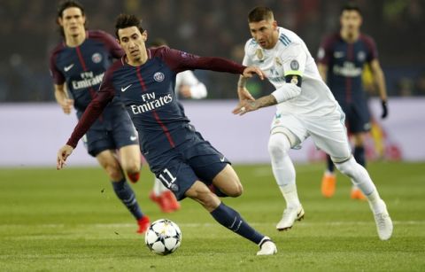 PSG's Angel Di Maria, left, and Real Madrid's Sergio Ramos, right, vie for the ball during the Champions League round of sixteen second leg soccer match between Paris St. Germain and Real Madrid at the Parc des Princes stadium in Paris, France, Tuesday, March 6, 2018. (AP Photo/Christophe Ena)