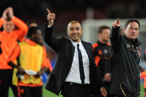 Chelsea's Italian coach Roberto Di Matteo (C) celebrates after beating Barcelona during the UEFA Champions League second leg semi-final football match Barcelona against Chelsea at the Cam Nou stadium in Barcelona on April 24, 2012.     AFP PHOTO / LLUIS GENE (Photo credit should read LLUIS GENE/AFP/Getty Images)