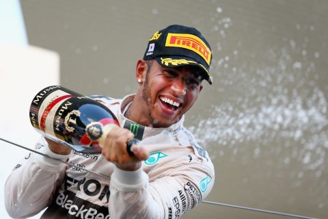 SUZUKA, JAPAN - SEPTEMBER 27:  Lewis Hamilton of Great Britain and Mercedes GP celebrates on the podium after winning the Formula One Grand Prix of Japan at Suzuka Circuit on September 27, 2015 in Suzuka, Japan.  (Photo by Clive Mason/Getty Images)
