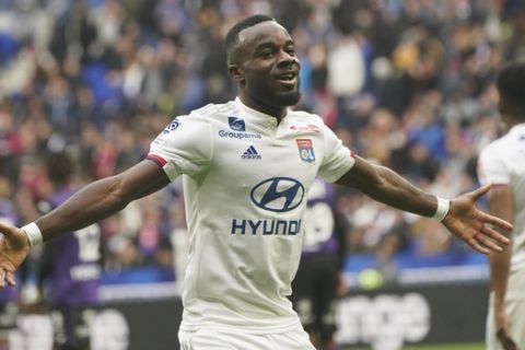 Lyon's Maxwel Cornet celebrates after scoring his side's first goal during the French League One soccer match between Lyon and Toulouse in Decines, outside Lyon, central France, Sunday, Jan. 26, 2020. (AP Photo/Laurent Cipriani)