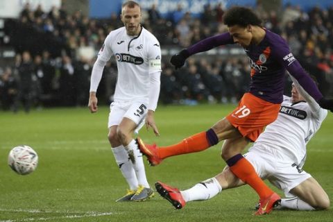 Manchester City's Leroy Sane attempts a shot on goal during their English FA Cup quarter final soccer match against Swansea City at the Liberty Stadium, Swansea, Wales, Saturday, March 16, 2019. (Nick Potts/PA via AP)