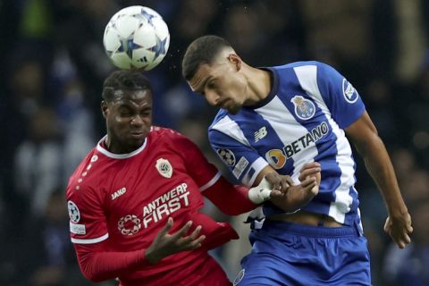 Porto's David Carmo fights for the ball with Royal Antwerp's George Ilenikhena during a Champions League group H soccer match between Porto and Antwerp at Estadio do Dragao in Porto, Portugal, Tuesday, Nov. 7, 2023. (AP Photo/Miguel Pereira)