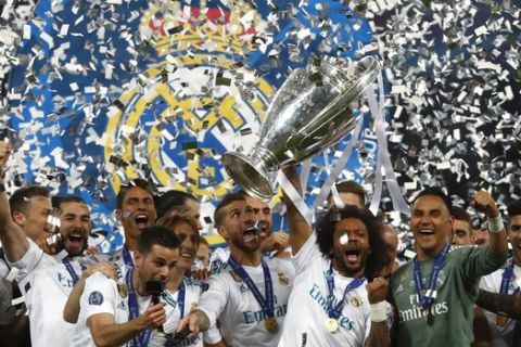 Real Madrid players celebrate with the trophy after winning the Champions League Final soccer match between Real Madrid and Liverpool at the Olimpiyskiy Stadium in Kiev, Ukraine, Saturday, May 26, 2018. (AP Photo/Matthias Schrader)