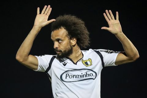 Famalicao's Fabio Martins celebrates after scoring the opening goal during the Portuguese League soccer match between FC Famalicao and FC Porto in Famalicao, Portugal, Wednesday, June 3, 2020. The Portuguese League soccer matches resumed Wednesday without spectators because of the coronavirus pandemic. (Jose Coelho/Pool via AP)