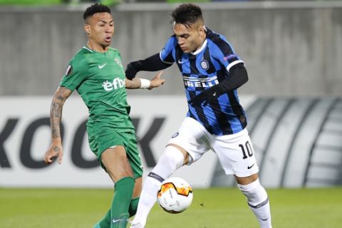 Inter Milan's Lautaro Martinez, right, challenges for the ball with Ludogorets' Wanderson during an Europa League, round of 32, first leg, soccer match between PFC Ludogorets Razgrad and Inter Milan at Huvepharma Arena in Razgrad, Bulgaria, Thursday, Feb. 20, 2020. (AP Photo/Vadim Ghirda)