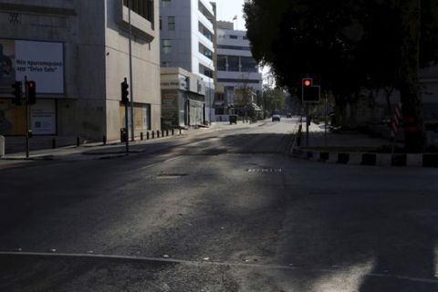 A main street is seen empty street in central capital Nicosia, Cyprus, Saturday, March 14, 2020. European Union member Cyprus has barred entry to all foreign nationals except for those who live, work and study on the island nation for the next 15 days in a bid to prevent the spread of the coronavirus. For most people, the new coronavirus causes only mild or moderate symptoms. For some it can cause more severe illness, especially in older adults and people with existing health problems. (AP Photo/Petros Karadjias)