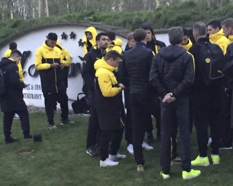 Head coach Thomas Tuchel, center, is surrouned by players after the bus of Borussia Dortmund was damaged after an explosion before the Champions League quarterfinal soccer match against AS Monaco in Dortmund, western Germany, Tuesday, April 11, 2017. (Carsten Linhoff/dpa via AP)