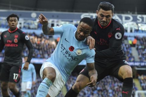 Manchester City's Raheem Sterling, left, and Arsenal's Sead Kolasinac battle for the ball during the English Premier League soccer match between Manchester City and Arsenal at Etihad stadium, Manchester, England, Sunday, Nov. 5, 2017. (AP Photo/Rui Vieira)